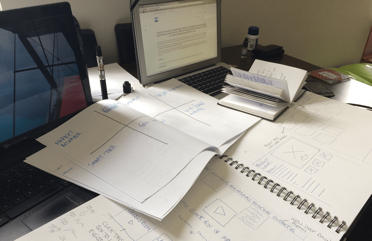 design sketches for software applications sit on a desk
