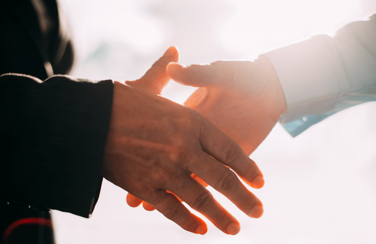 close up of two people shaking hands