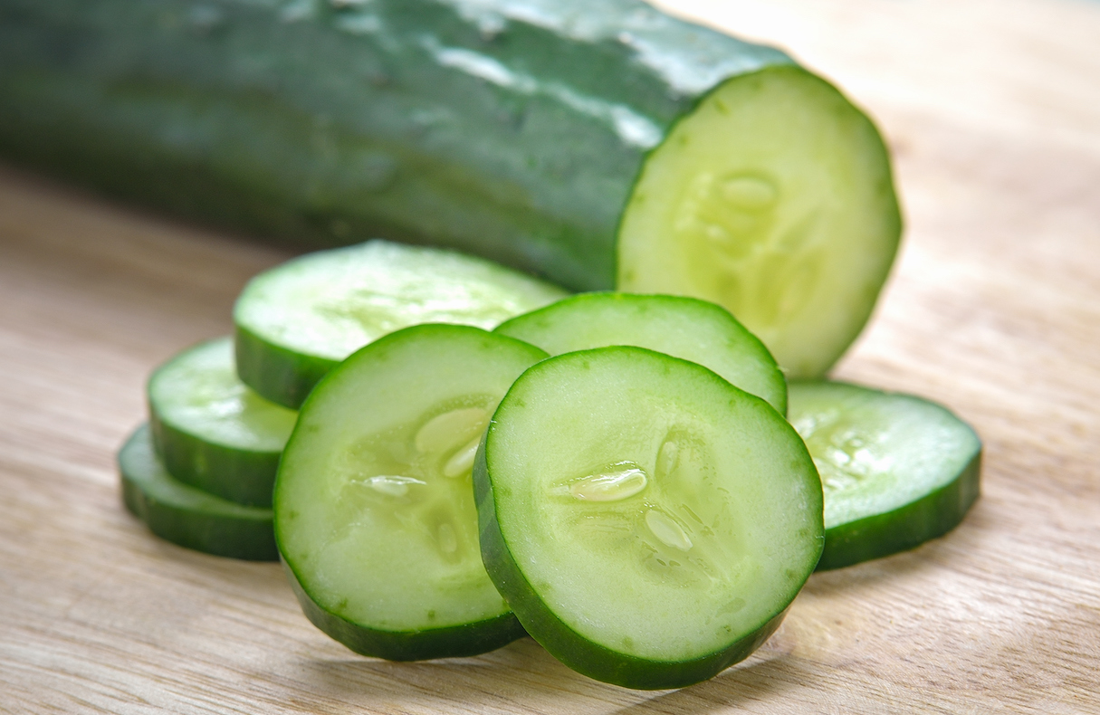 Fresh Cucumber slices on wood background