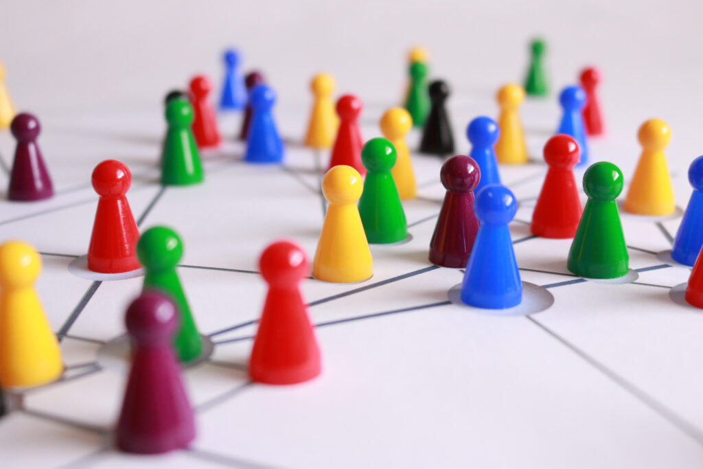 Brightly colored board game pieces sit on a white surface