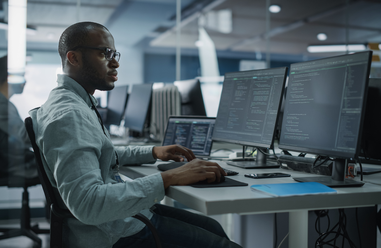 Professional Black IT Programmer Working on Desktop Computer