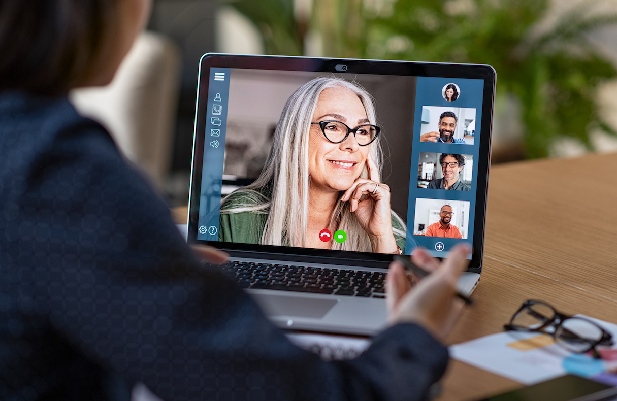 person on video call looking at laptop