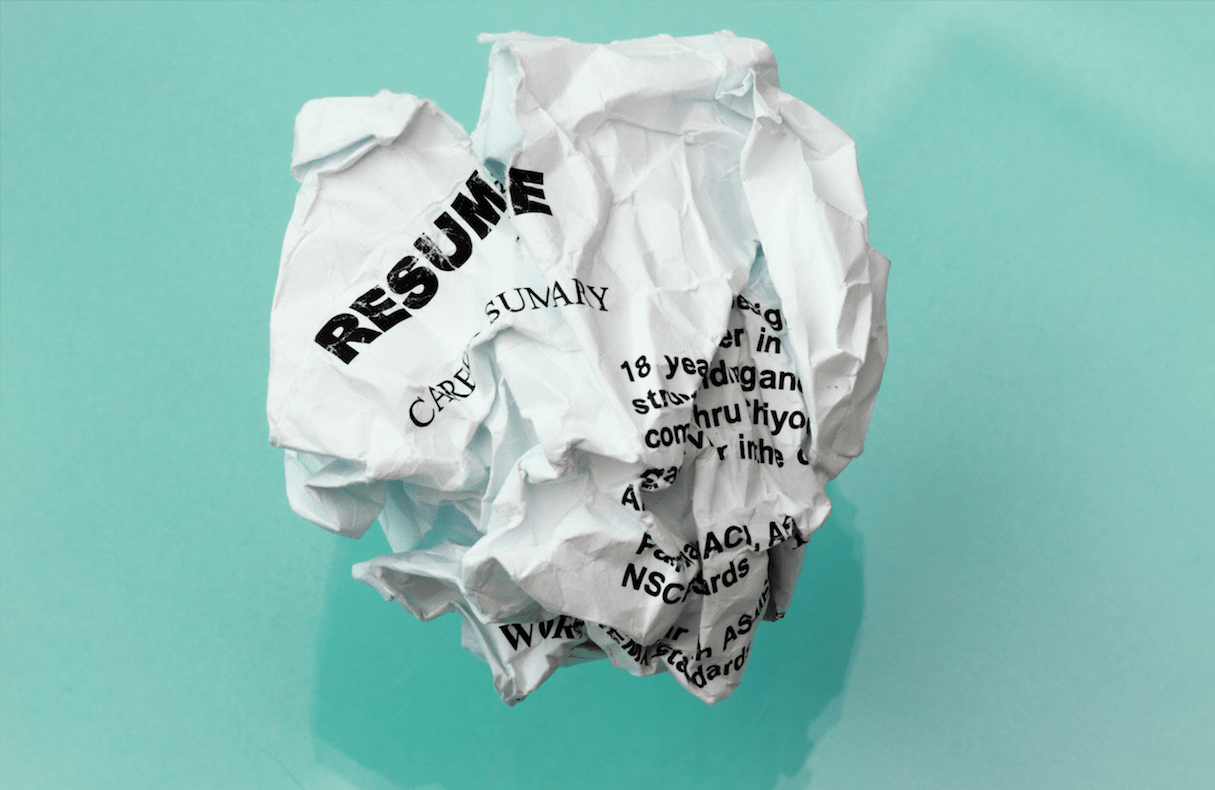 crumpled up piece of paper with the word "resume" on it.