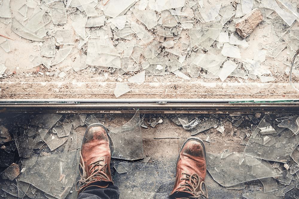 leather boots standing in pile of broken glass