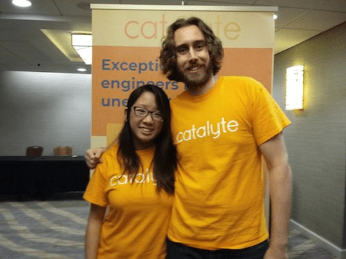 Woman on left and man on right wearing orange shirts that say Catalyte