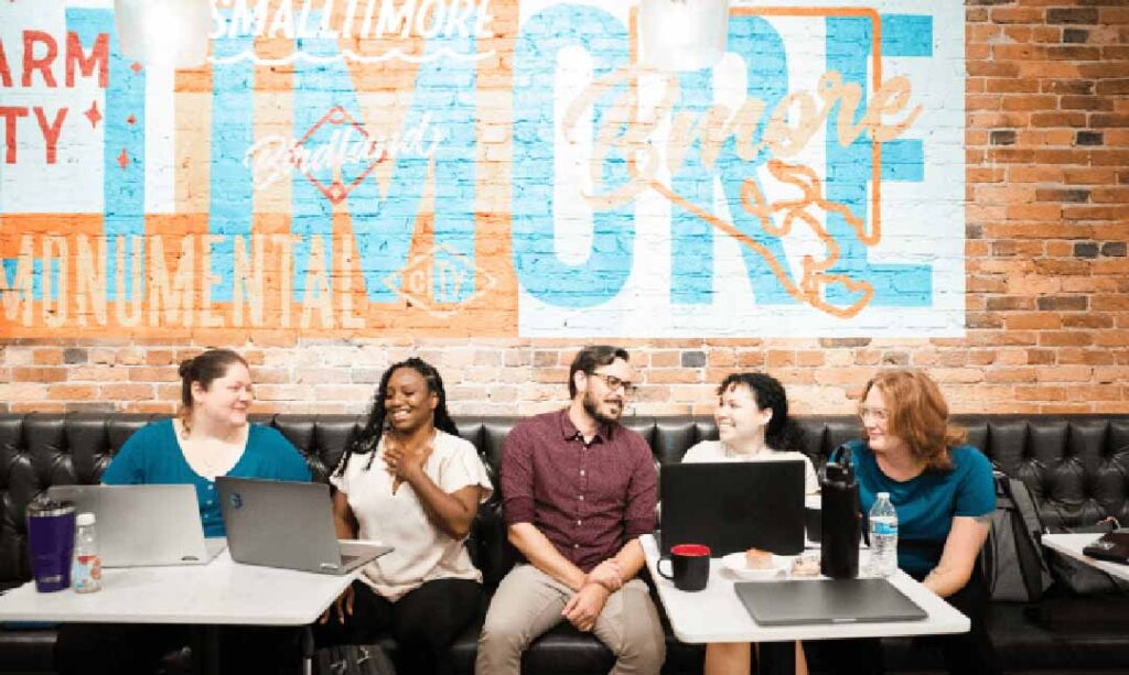 A diverse group of five software developers collaborating on a new initiative.