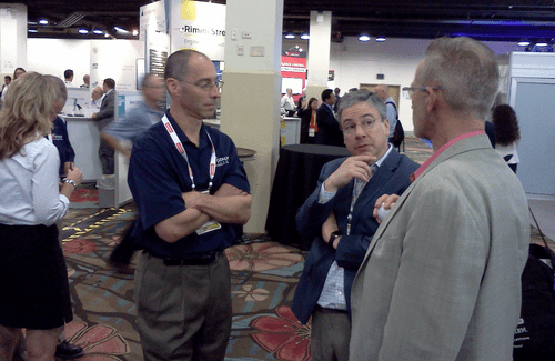 Two Catalyte employees talk to potential client at a trade show