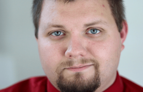 Close up of man with goatee and red shirt