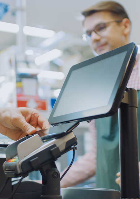 Person pays with their phone at grocery check out