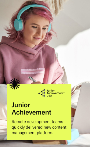 Teenage girl with pink hair and blue headphones sits on her bed working on computer, with text that reads: Junior Achievement, remote deployment teams quickly delivered new content management platform