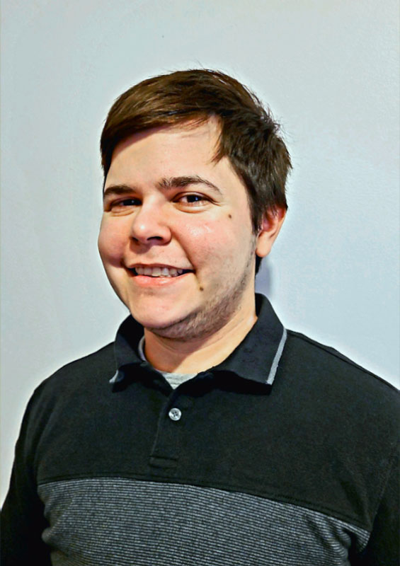 Man wearing grey polo shirt and short brown hair